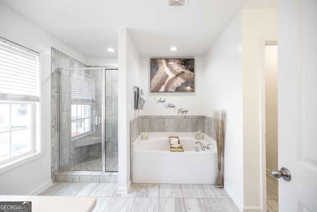 209 Adirondac Way Bonaire, GA 31005 - Photo 12 of 22 a bathroom with a tub a sink and glass door