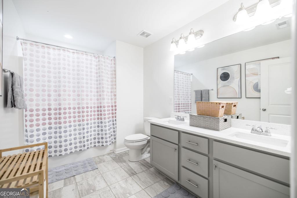 209 Adirondac Way Bonaire, GA 31005 - Photo 16 of 22 a bathroom with a sink toilet and shower