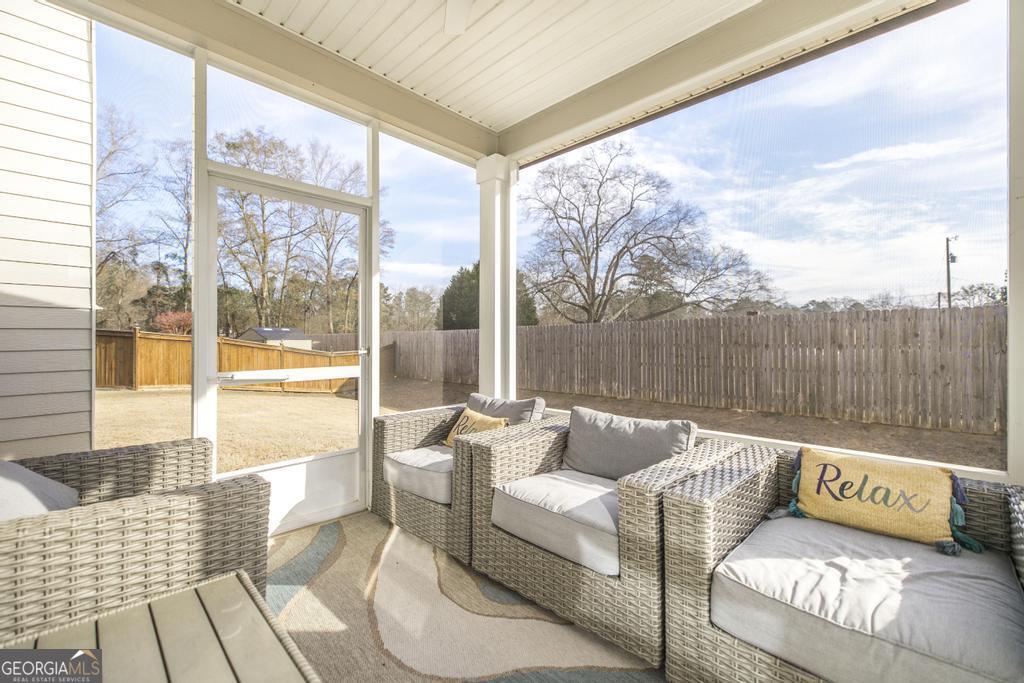 209 Adirondac Way Bonaire, GA 31005 - Photo 19 of 22 a living room with furniture and a floor to ceiling window