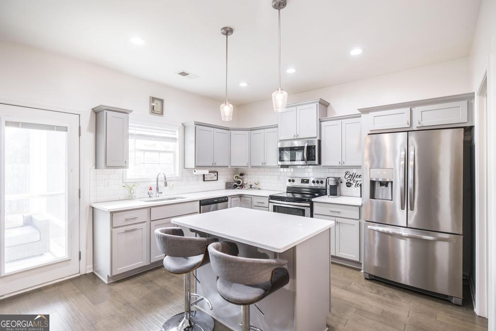 209 Adirondac Way Bonaire, GA 31005 - Photo 3 of 22 a kitchen with stainless steel appliances a stove a sink a refrigerator a center island and a cabinets