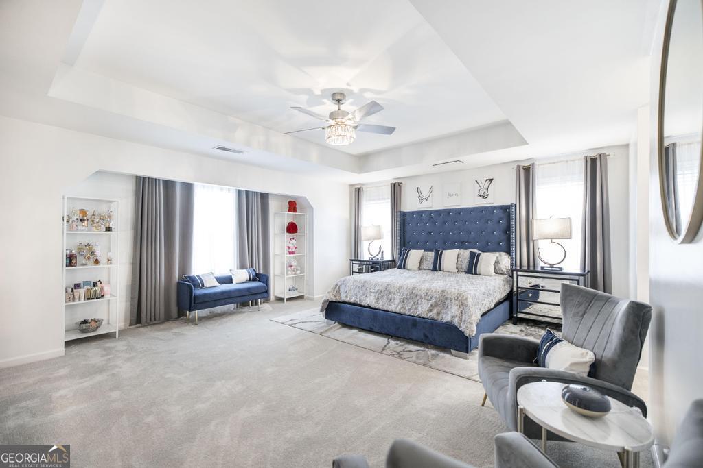 209 Adirondac Way Bonaire, GA 31005 - Photo 7 of 22 a spacious bedroom with a bed a couch and a chandelier