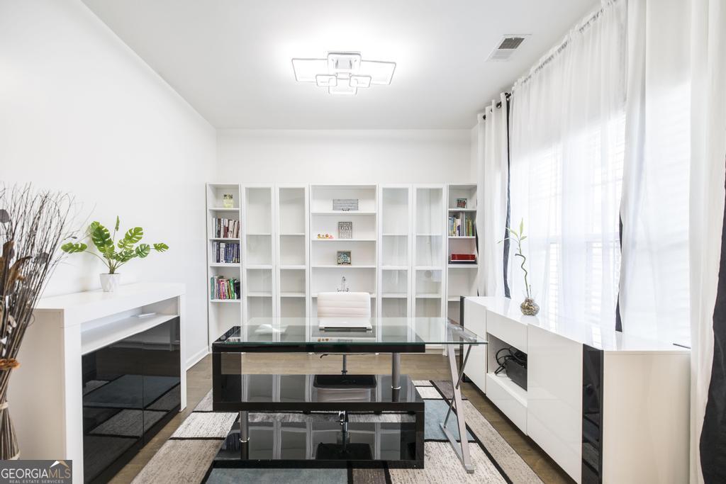 209 Adirondac Way Bonaire, GA 31005 - Photo 8 of 22 a kitchen with stainless steel appliances a white cabinets and a fireplace