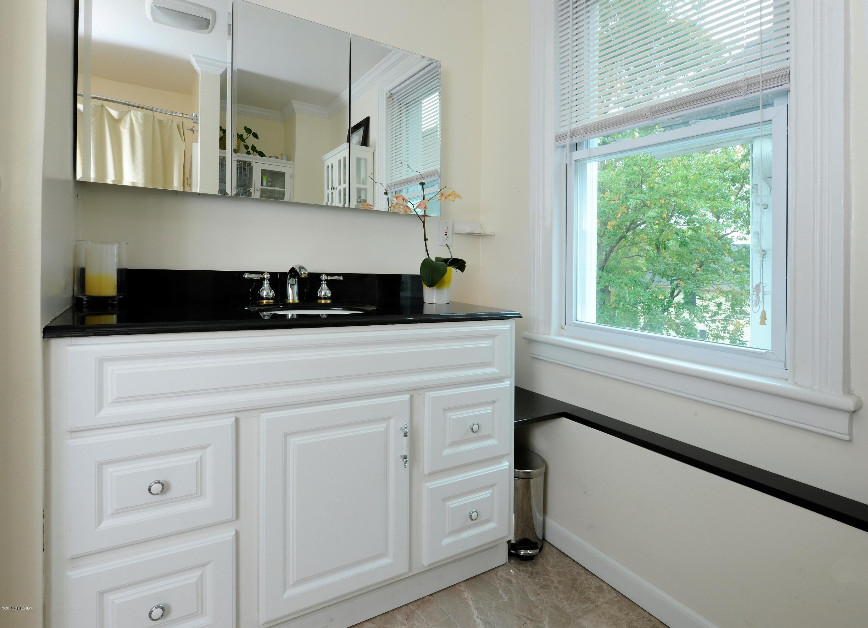 20 Division Street Greenwich, CT 06830 - Photo 12 of 19 a kitchen with white cabinets and window