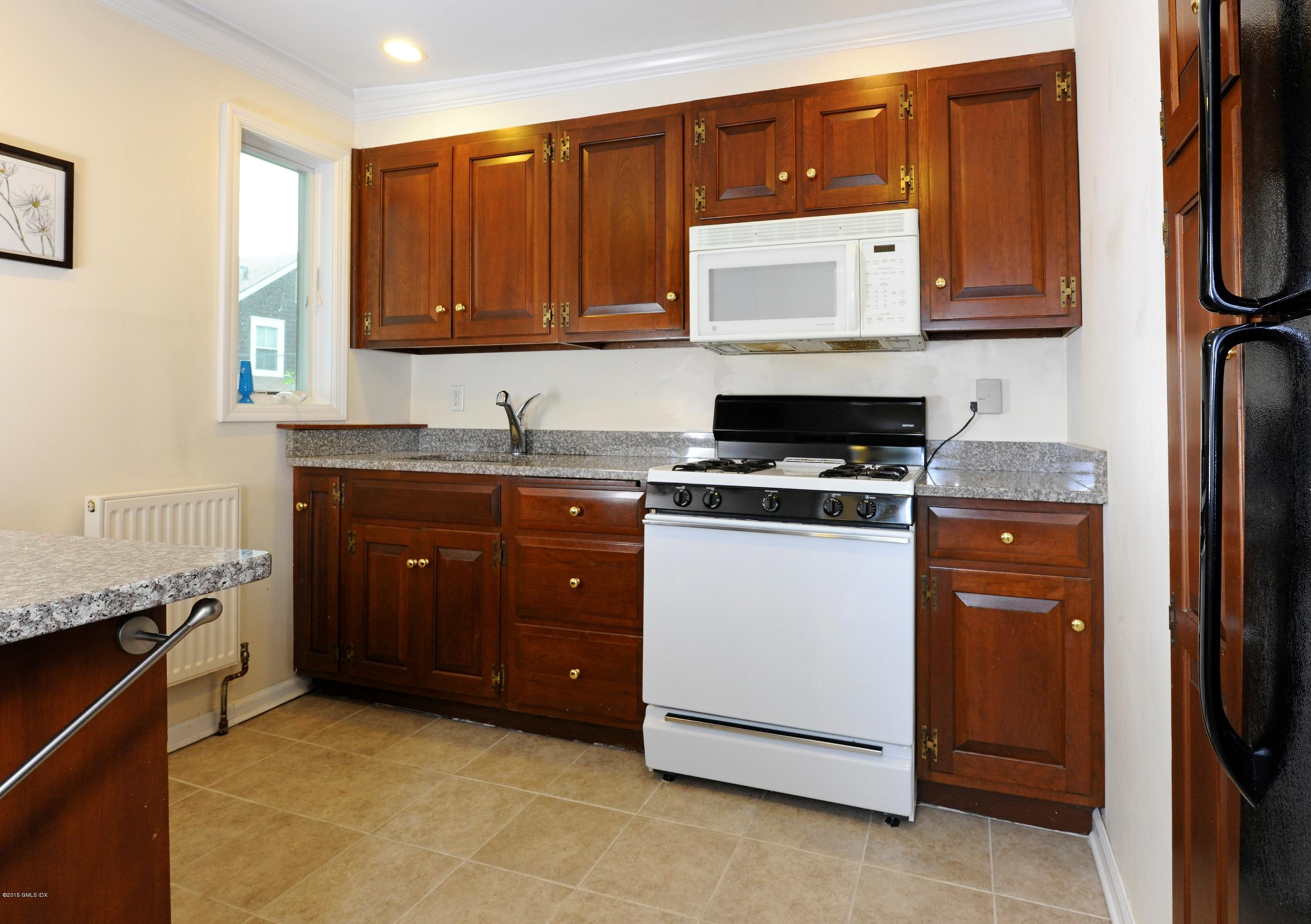 20 Division Street Greenwich, CT 06830 - Photo 16 of 19 a kitchen with a cabinets and a stove top oven