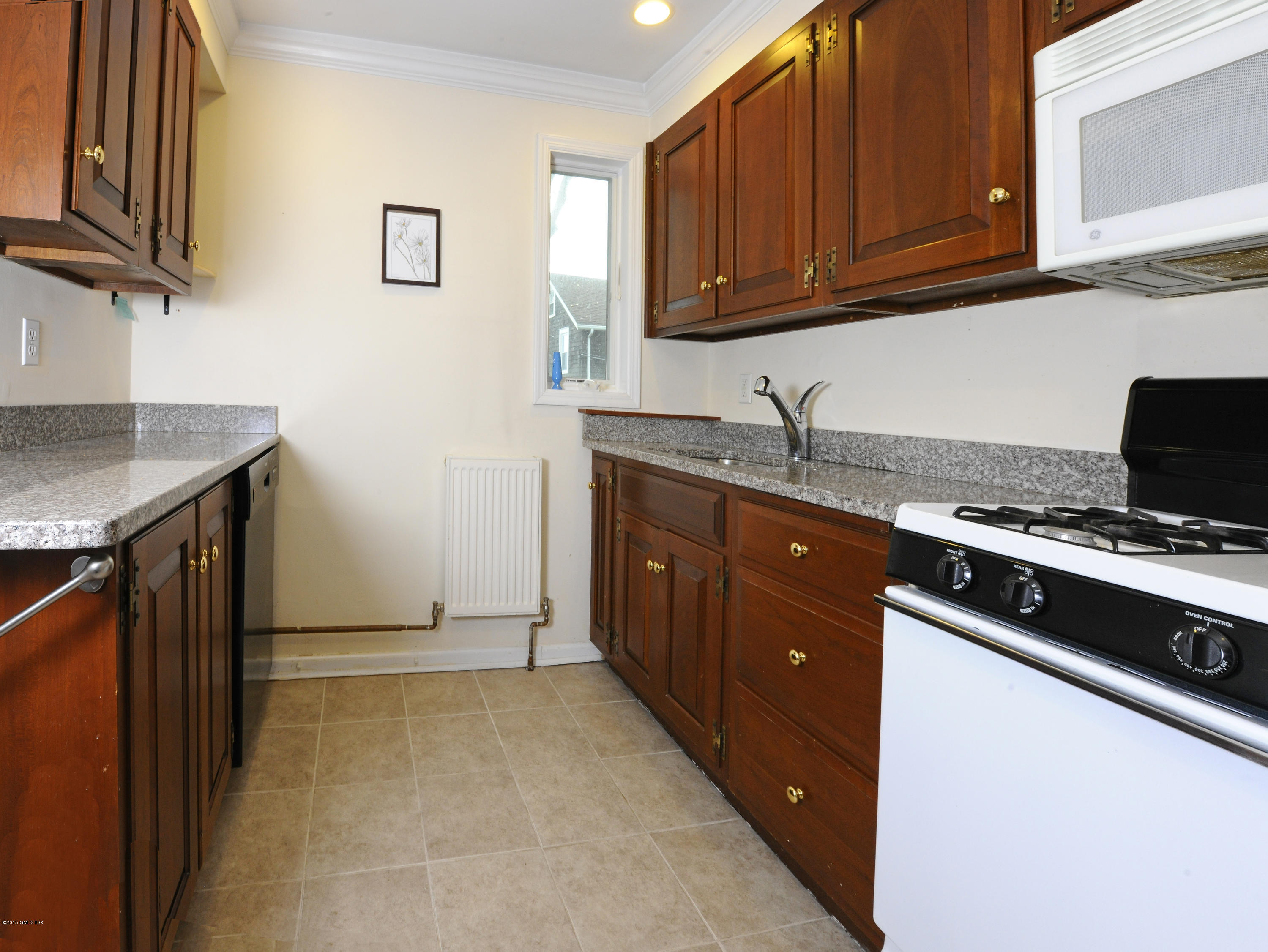 20 Division Street Greenwich, CT 06830 - Photo 17 of 19 a kitchen with granite countertop a sink a stove and cabinets