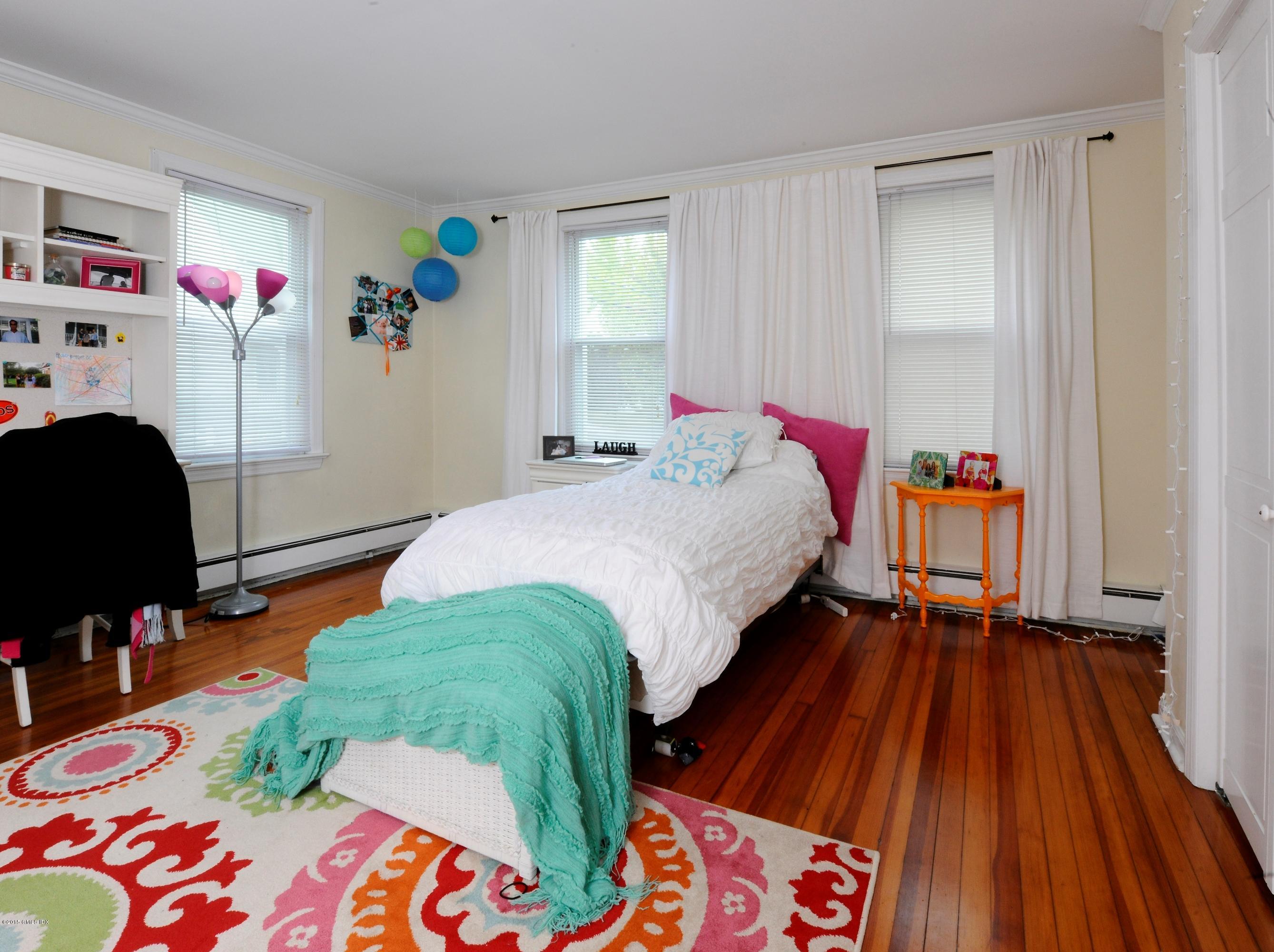 20 Division Street Greenwich, CT 06830 - Photo 18 of 19 a bedroom with a bed and wooden floor
