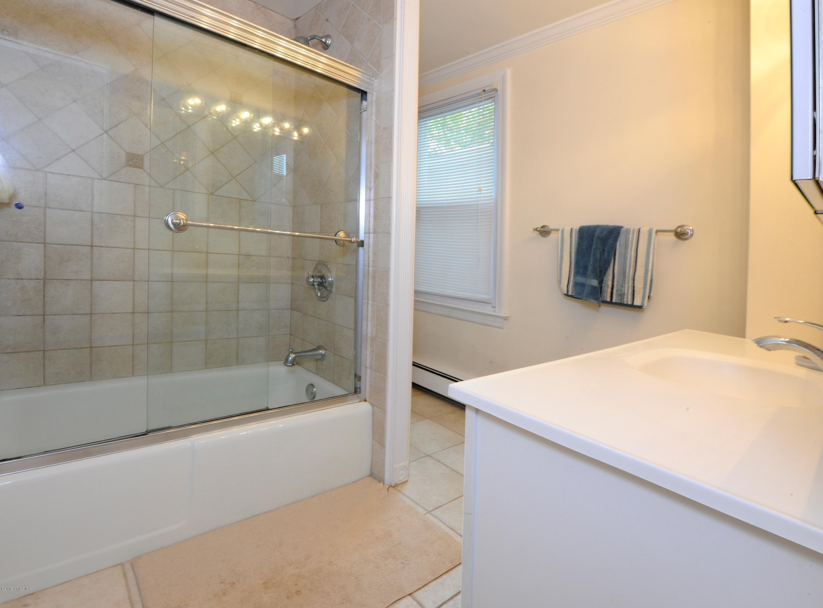 20 Division Street Greenwich, CT 06830 - Photo 19 of 19 a bathroom with a bathtub and a shower