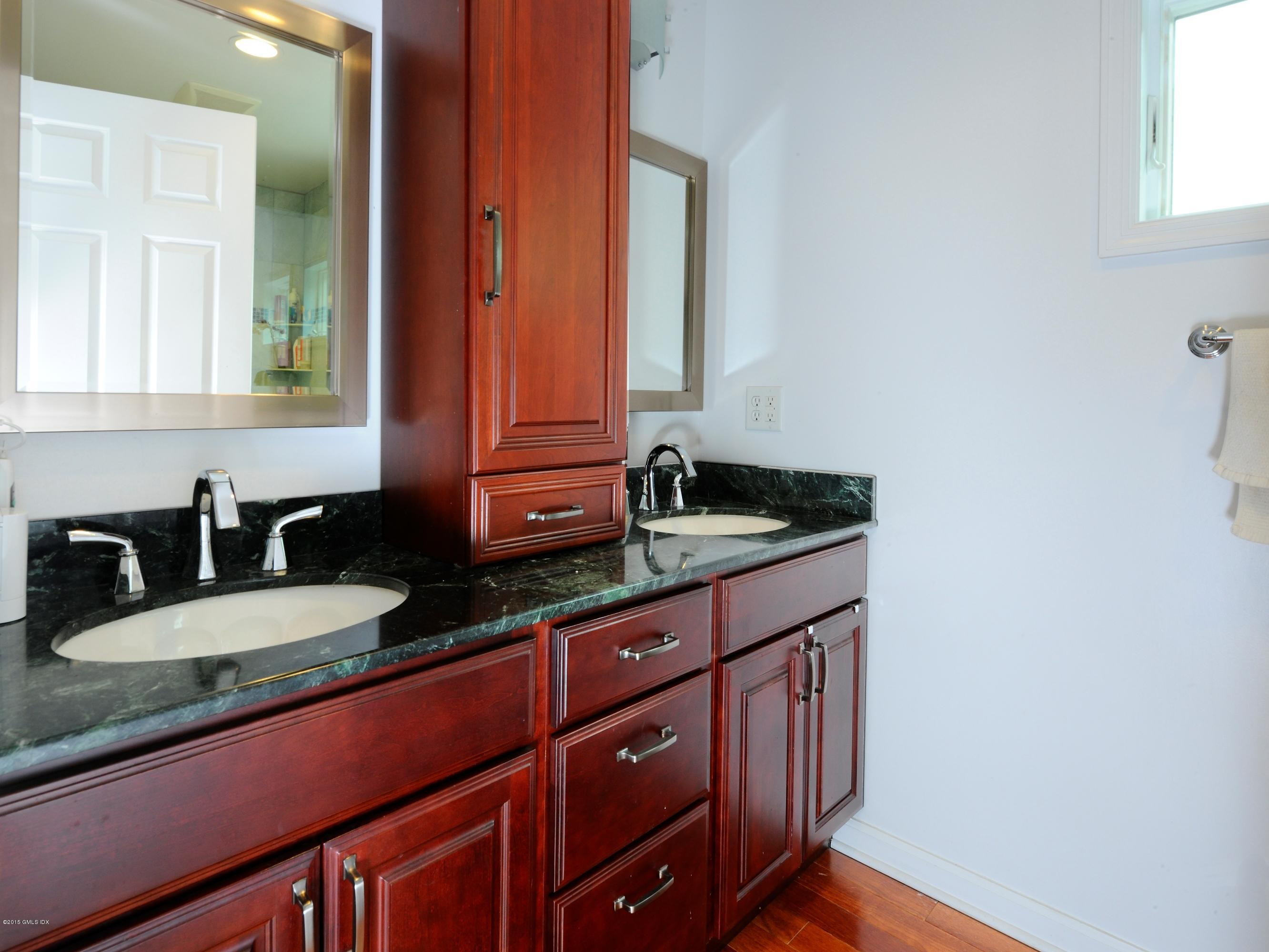 20 Division Street Greenwich, CT 06830 - Photo 10 of 19 a bathroom with granite countertop double vanity and mirror
