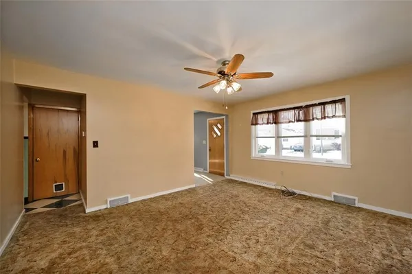 a view of an empty room with a window