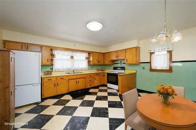 a kitchen with granite countertop stainless steel appliances a sink and a refrigerator