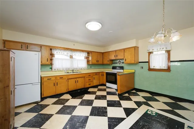 a kitchen with granite countertop stainless steel appliances a sink and a refrigerator