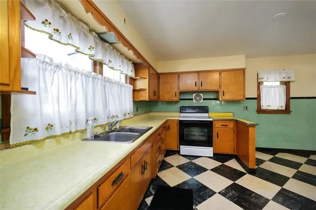 a kitchen with a stove sink and cabinets