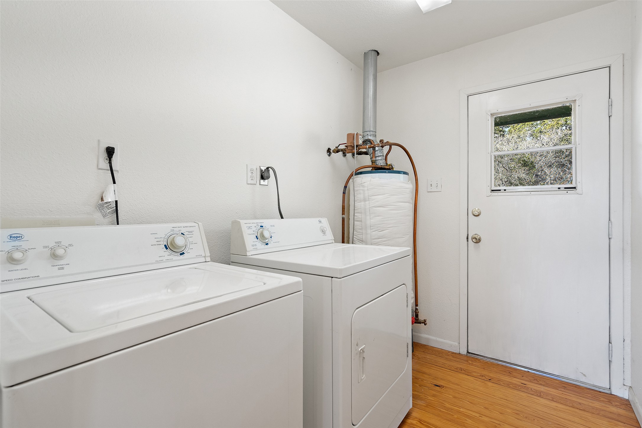 1401 Pursley Road Dripping Springs, TX 78620 - Photo 9 of 35 Laundry room featuring light wood-style floors and washer and clothes dryer