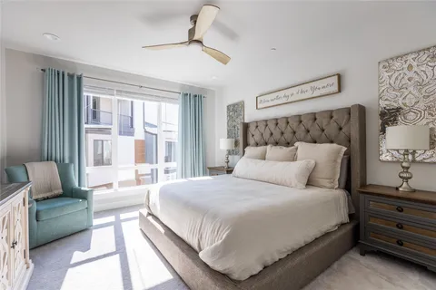 a bedroom with a large bed and a couch