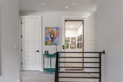 a bathroom with a painting on the wall and a window