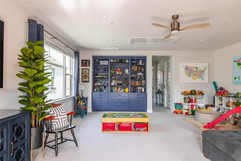 a play room with furniture and a potted plant