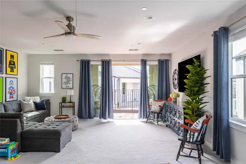 a living room with patio furniture and a potted plant