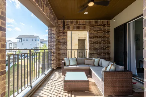 a balcony with furniture and a potted plant