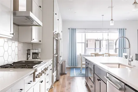 a kitchen with stainless steel appliances granite countertop a sink stove and refrigerator