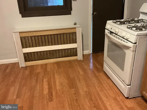 a white refrigerator freezer and a wooden floor