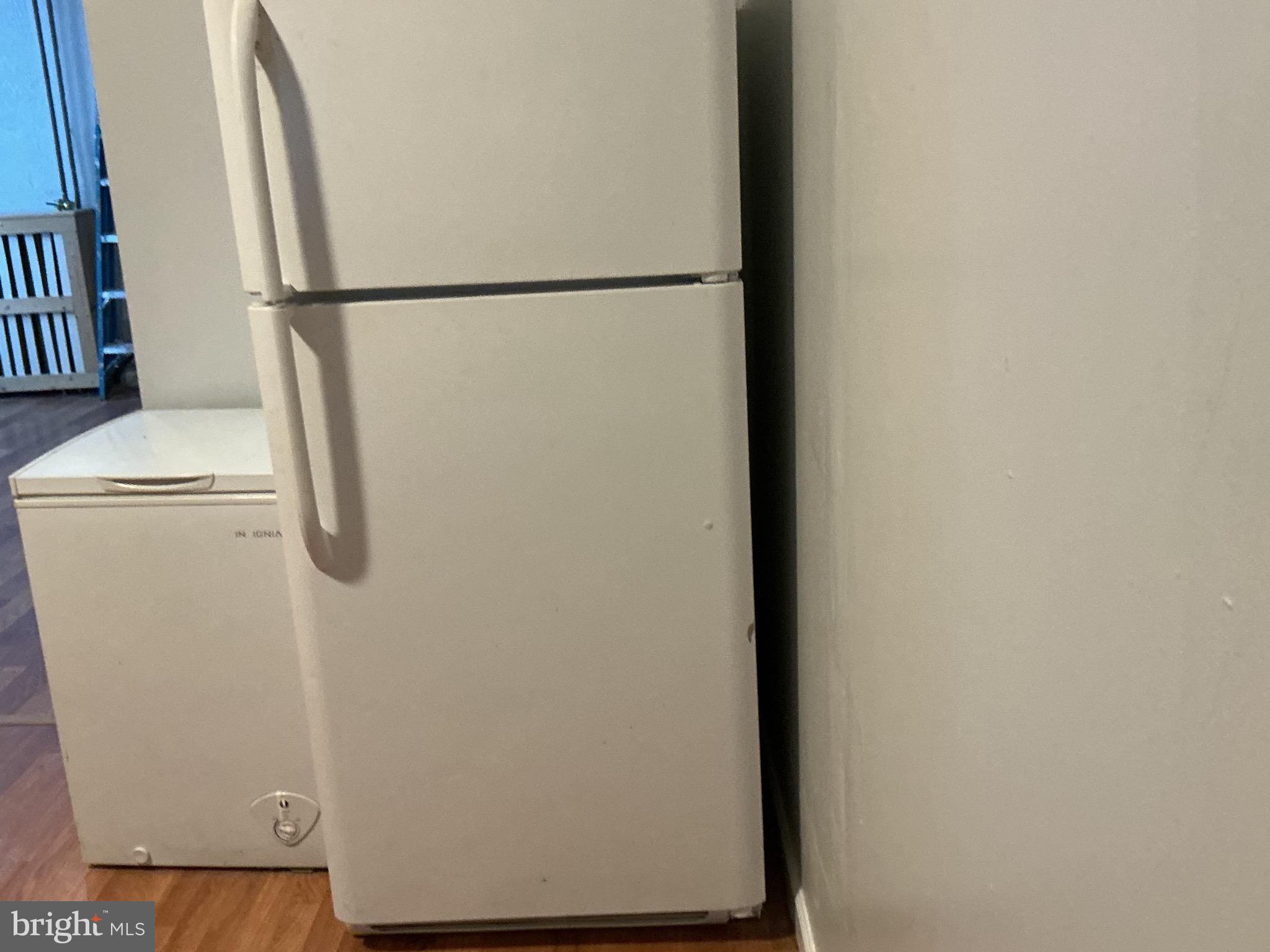 5010 Belair Road Baltimore, MD 21206 - Photo 14 of 24 a white refrigerator freezer and a wooden floor