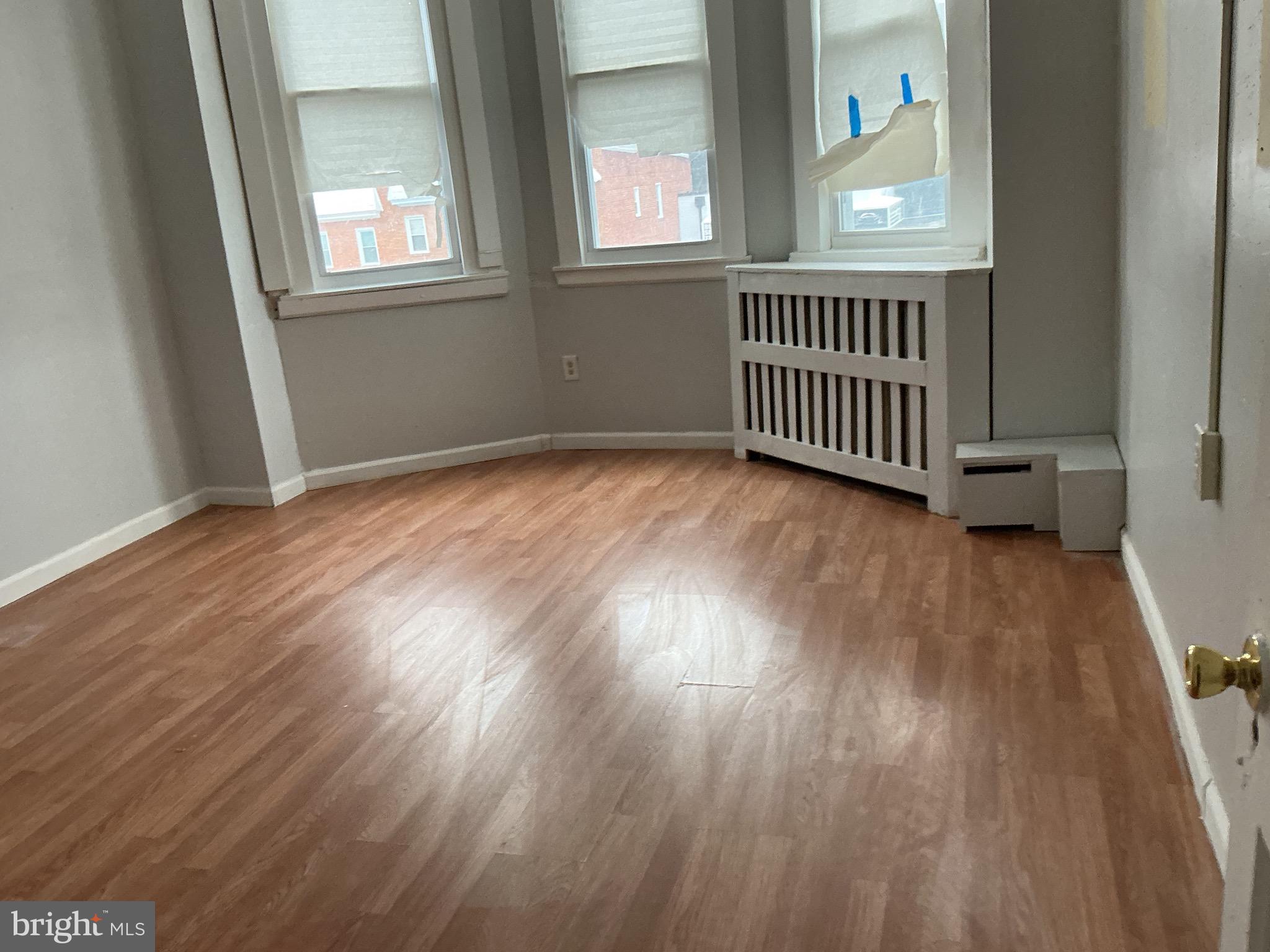5010 Belair Road Baltimore, MD 21206 - Photo 21 of 24 an empty room with wooden floor and windows