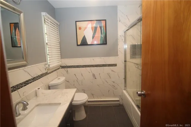 a bathroom with a toilet and a shower