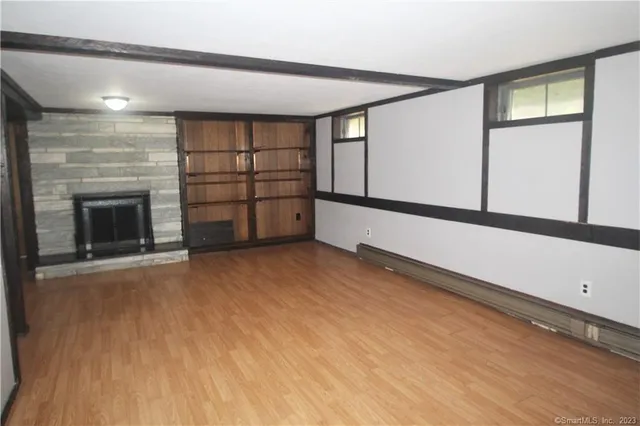 a view of a livingroom with an empty space and a fireplace