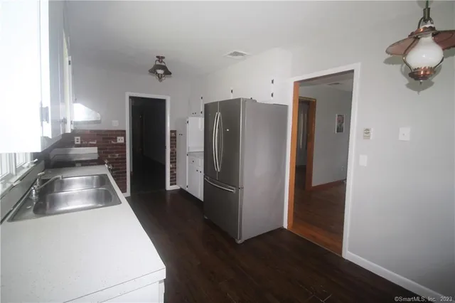 a kitchen with a refrigerator and a sink