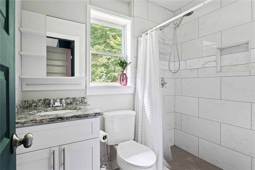 2280 Larchwood Road Southwest Atlanta, GA 30310 - Photo 11 of 20 a bathroom with a sink toilet and shower