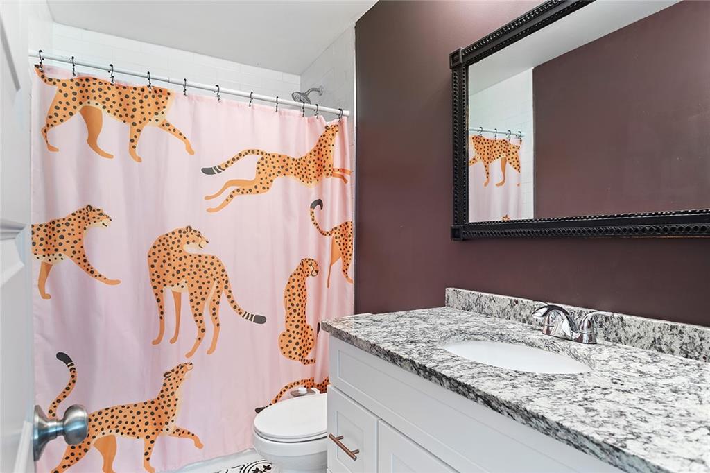 2280 Larchwood Road Southwest Atlanta, GA 30310 - Photo 14 of 20 a bathroom with a granite countertop sink and a mirror