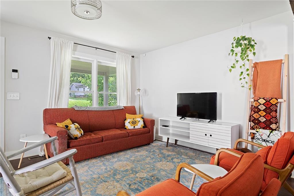 2280 Larchwood Road Southwest Atlanta, GA 30310 - Photo 4 of 20 a living room with furniture and a flat screen tv