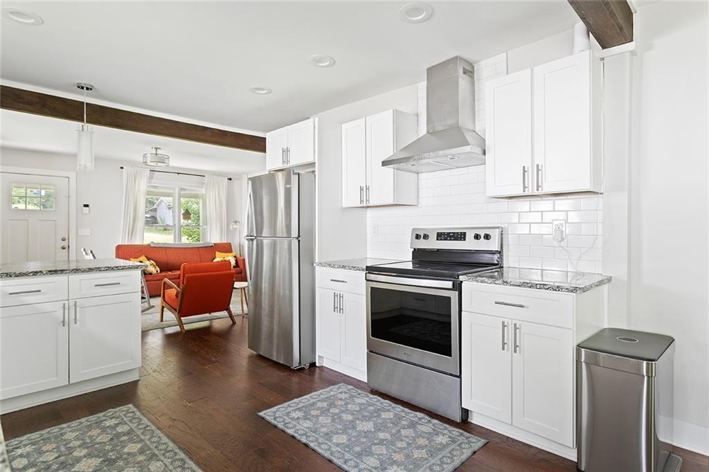 2280 Larchwood Road Southwest Atlanta, GA 30310 - Photo 6 of 20 a kitchen with stainless steel appliances a stove a refrigerator and white cabinets