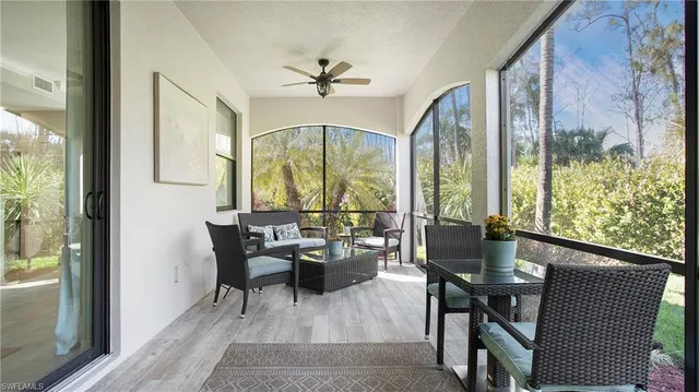 a dining room with furniture a chandelier and wooden floor