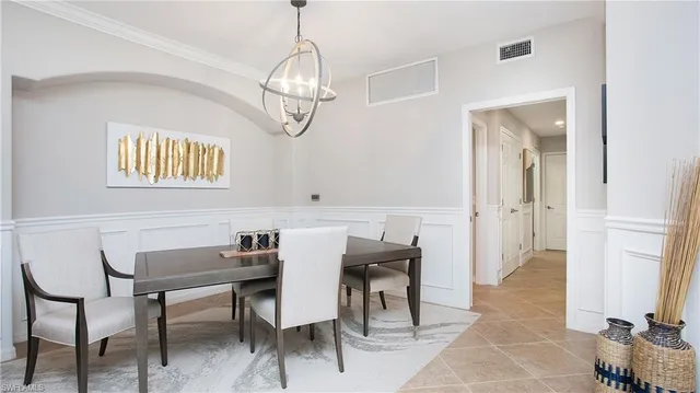 a view of a dining room with furniture and chandelier