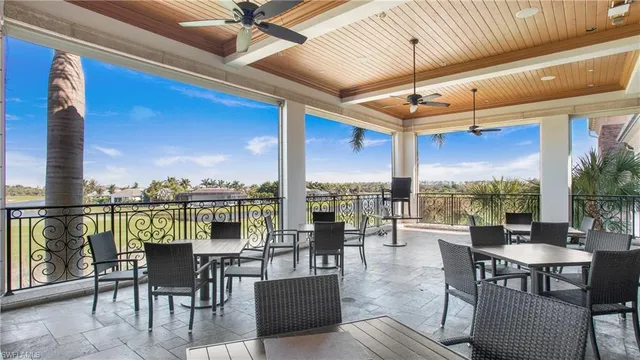 a roof deck with couches and potted plants