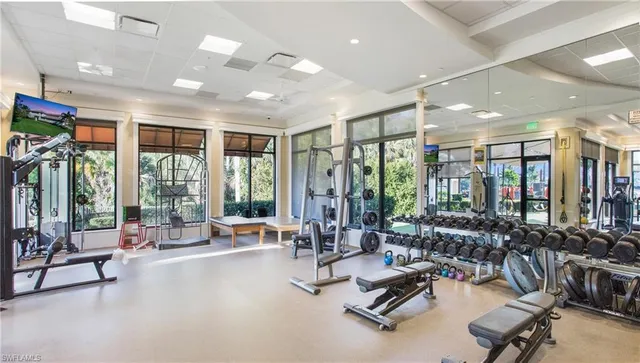 a view of a room with gym equipment and floor to ceiling window