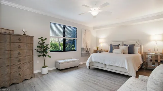 a spacious bedroom with a bed and a window