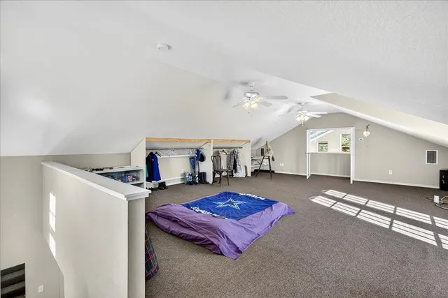 a spacious bedroom with a bed and cabinets