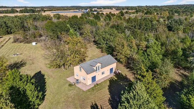 an aerial view of a house with a yard