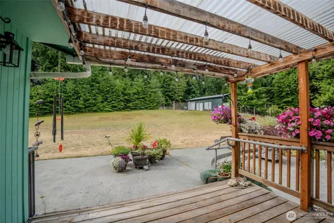 a view of a patio with table and chairs potted plants with wooden floor