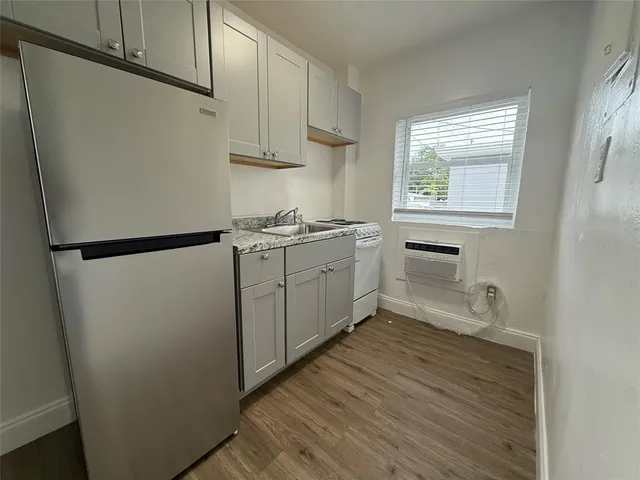 a kitchen with sink cabinets and window