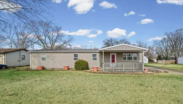 a front view of house with yard and green space