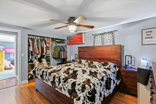 a bed sitting in a bedroom next to a window