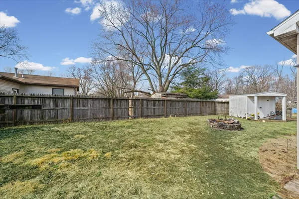 a backyard of a house with wooden fence