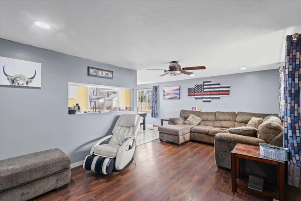 a living room with furniture and wooden floor