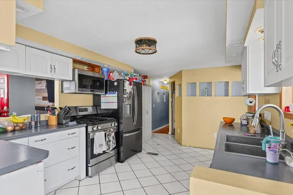 a kitchen with stainless steel appliances a stove a sink and a refrigerator