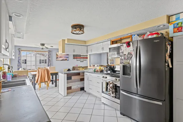 a kitchen with stainless steel appliances a refrigerator and a stove top oven