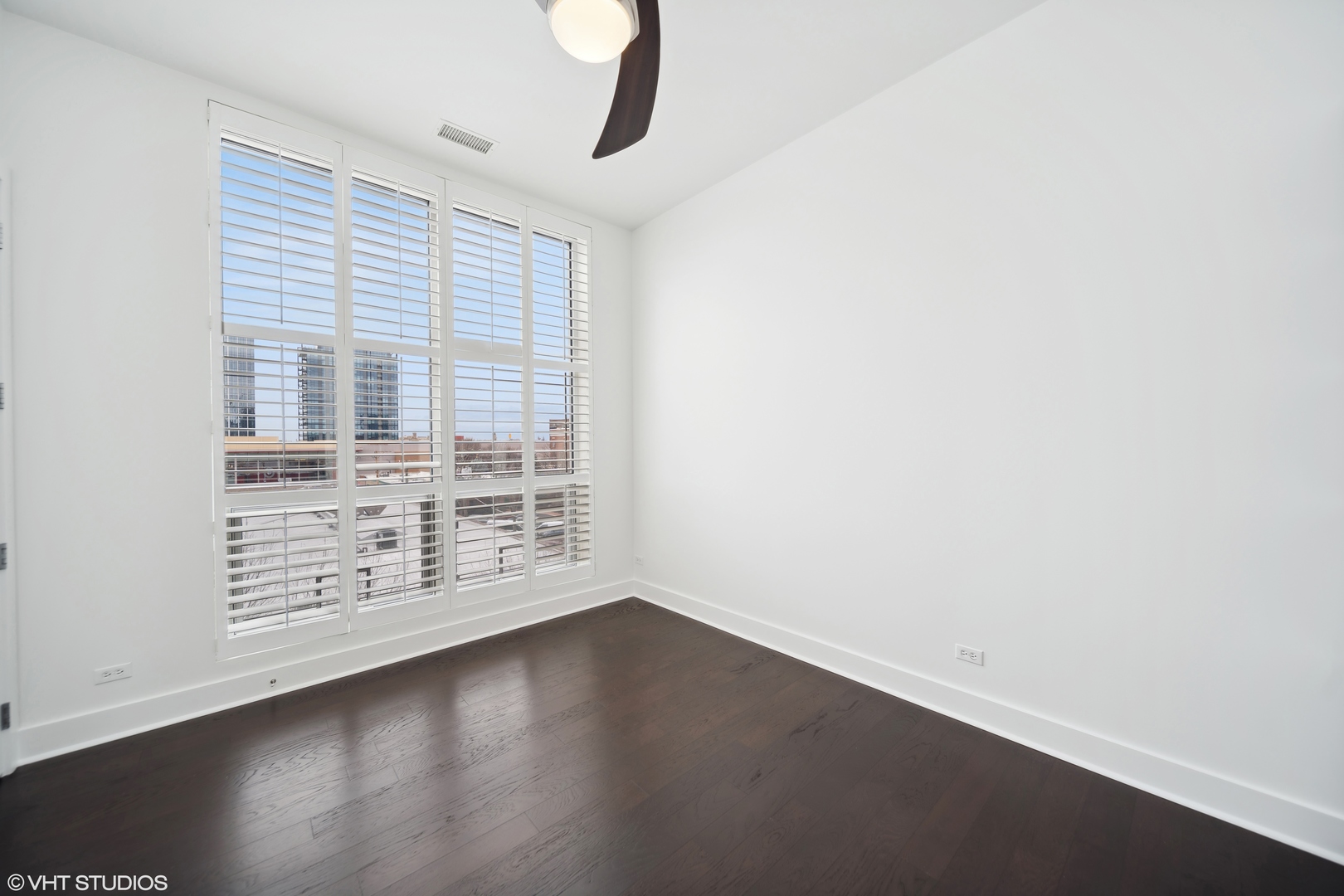 1100 West Adams Street, Unit 4S Chicago, IL 60607 - Photo 11 of 21 an empty room with wooden floor and windows