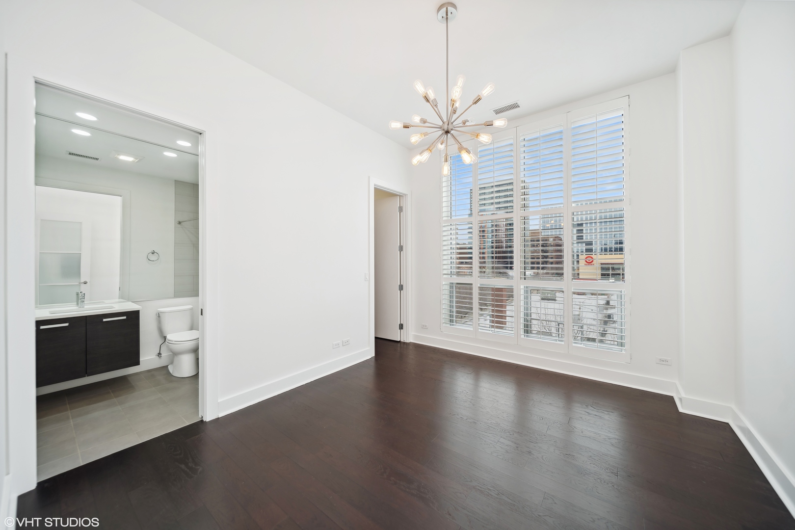1100 West Adams Street, Unit 4S Chicago, IL 60607 - Photo 15 of 21 an empty room with wooden floor and windows